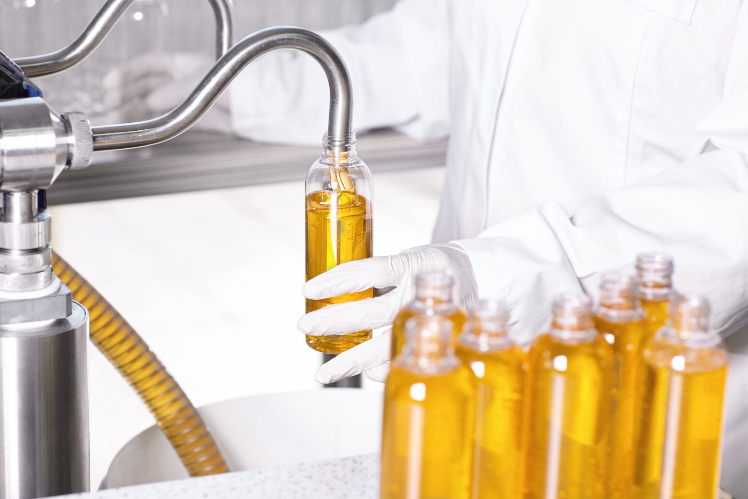 A technician fills bottles with CanolaMAX cooking oil at a processing plant.