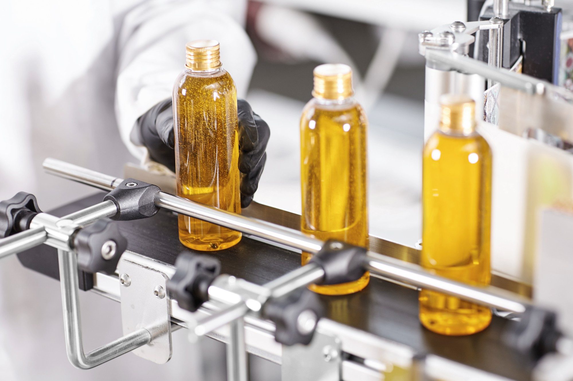 Inspection of StableMAX cooking oil bottles on a production line.