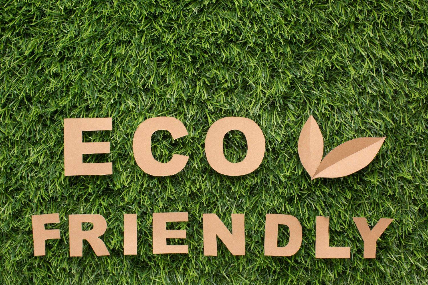 The words "Eco-Friendly" crafted from brown paper on a green grass background, symbolizing eco-friendly used cooking oil management and sustainable practices.
